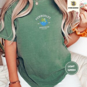 Person wearing a light green Pemberley Floral Teapot Embroidered T-Shirt