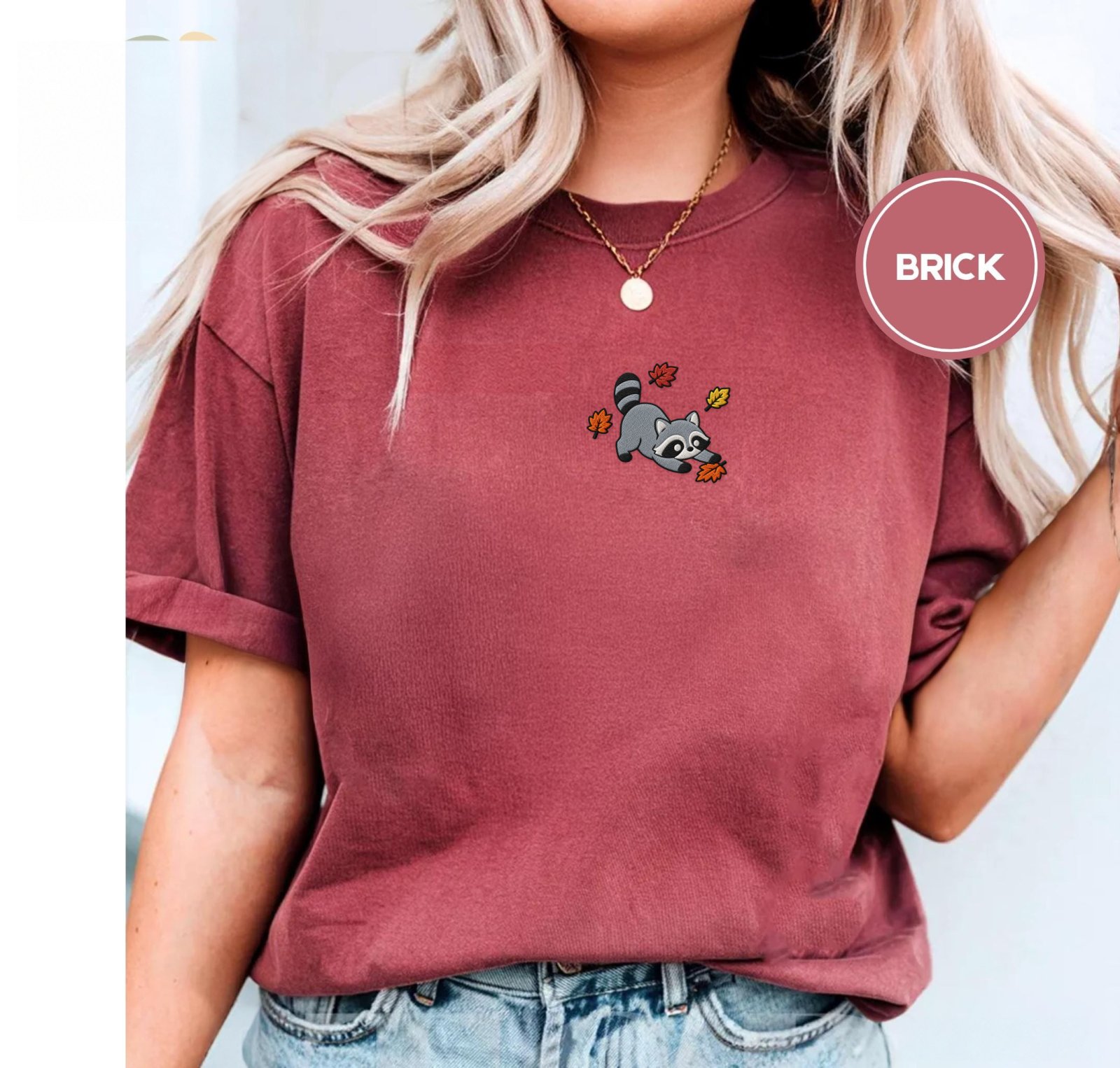 Person wearing a brick Playful Autumn Raccoon Embroidered T-Shirt