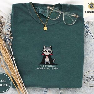 Blue Spruce Plotting Scheming Vampire Raccoon Embroidered T-Shirt