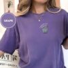 Person wearing a grape Problem Goat Embroidered T-Shirt
