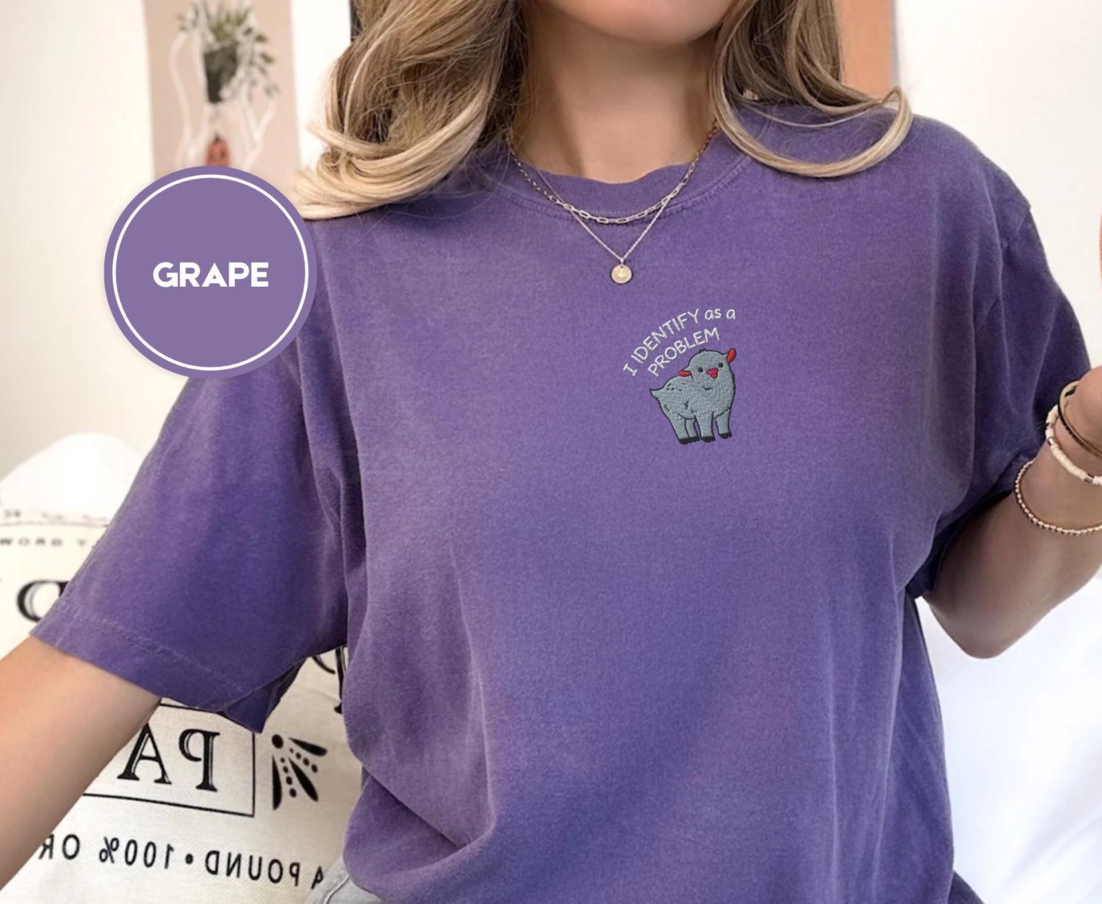 Person wearing a grape Problem Goat Embroidered T-Shirt