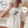 Person wearing an ivory Purple and Blue Butterflies Embroidered T-Shirt