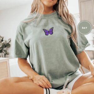 Person wearing a bay Purple Butterfly Embroidered T-Shirt
