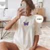 Person wearing an ivory Purple Butterfly Embroidered T-Shirt