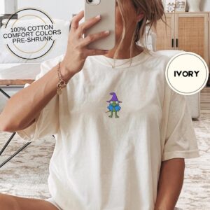 Person wearing an ivory Purple Hat Frog Embroidered T-Shirt