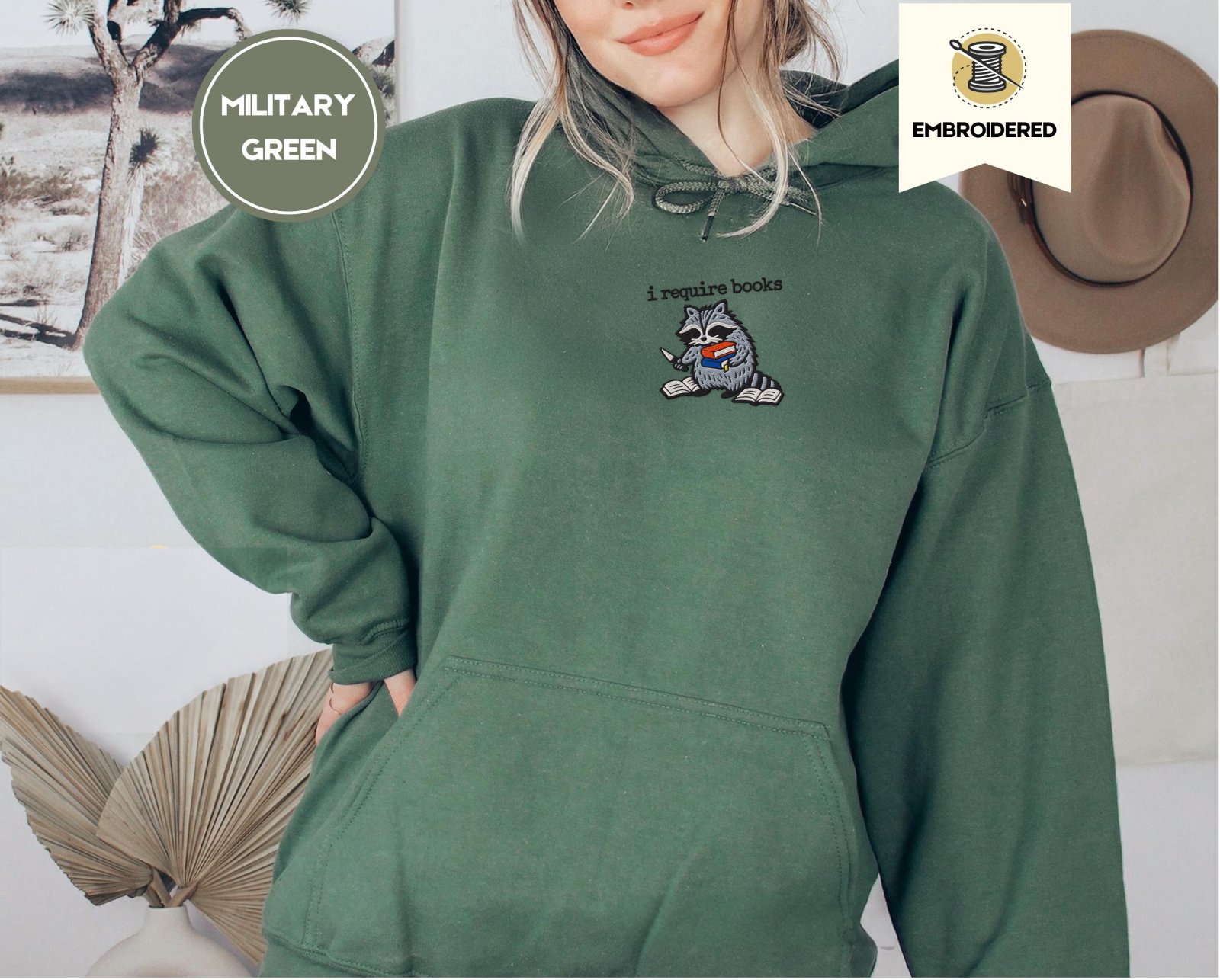 Person wearing a military green Raccoon and Open Books Embroidered Hoodie