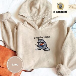 Sand Raccoon and Open Books Embroidered Hoodie