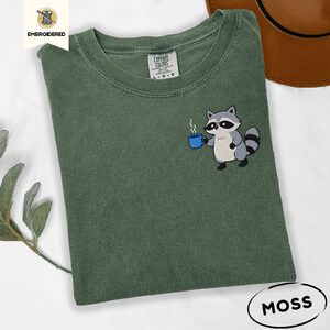 Moss Raccoon Holding Blue Coffee Mug Embroidered T-Shirt
