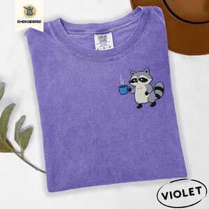 Violet Raccoon Holding Blue Coffee Mug Embroidered T-Shirt