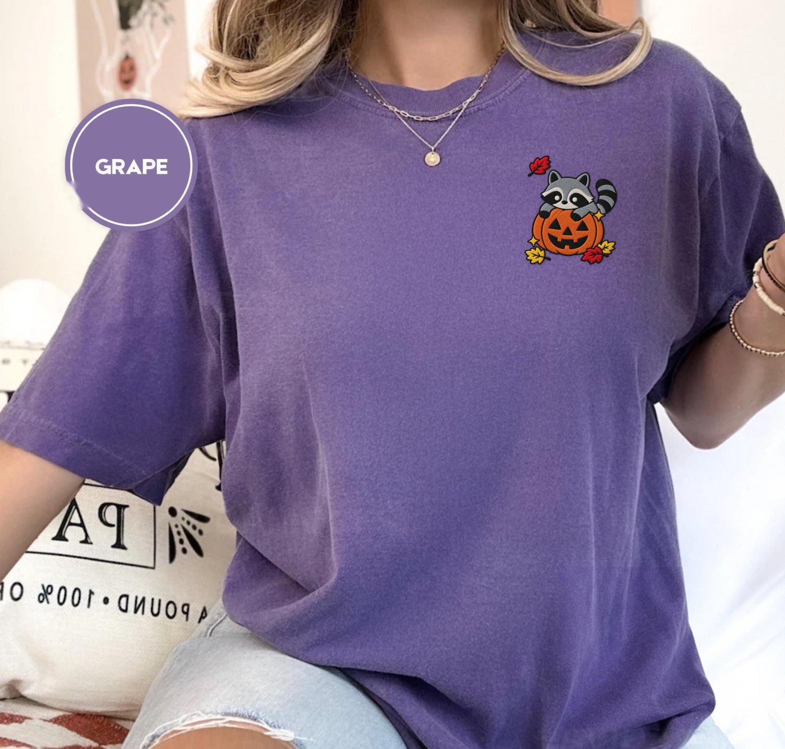 Person wearing a grape Raccoon Jack-O-Lantern Embroidered T-Shirt