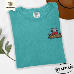 Seafoam Raccoon Reading on Log Embroidered T-Shirt