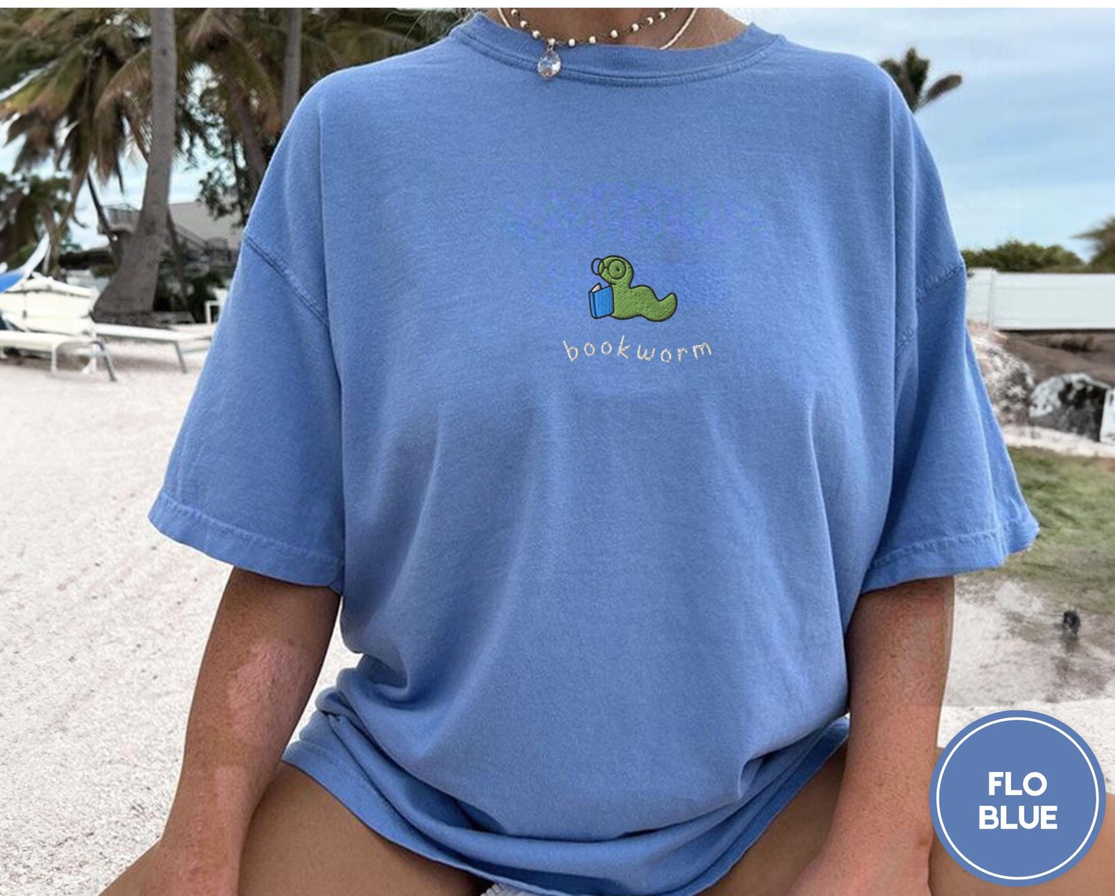 Person wearing a flo blue Reading Bookworm Embroidered T-Shirt