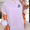 Person wearing an orchid Reading Cat Embroidered T-Shirt