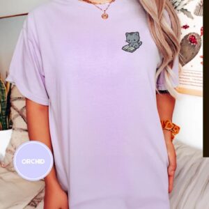 Person wearing an orchid Reading Cat Embroidered T-Shirt