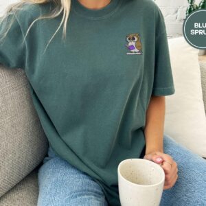 Person wearing a blue spruce Reading Owl Embroidered T-Shirt