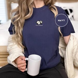 Person wearing a navy Reclining Black and White Panda Embroidered T-Shirt