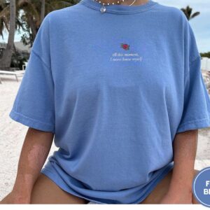 Person wearing a flo blue Rose and Literary Quote Embroidered T-Shirt