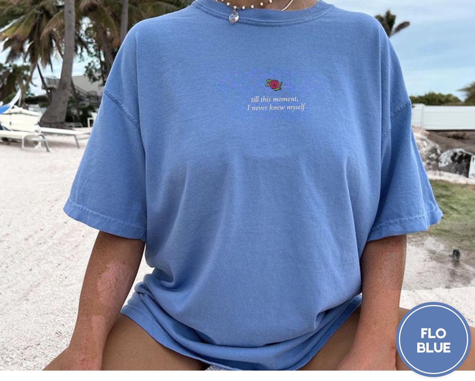 Person wearing a flo blue Rose and Literary Quote Embroidered T-Shirt