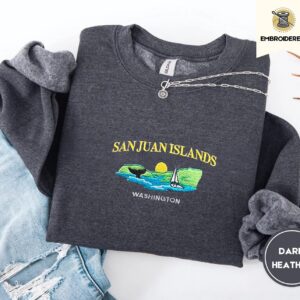 Dark Heather crewneck sweatshirt embroidered with San Juan Islands, Washington, an orca tail, a sailboat and a setting sun