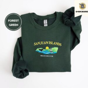 Forest Green crewneck sweatshirt embroidered with San Juan Islands, Washington, an orca tail, a sailboat and a setting sun
