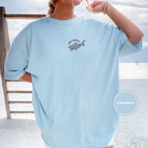 Person wearing a chambray Sea Puppy Shark Embroidered T-Shirt