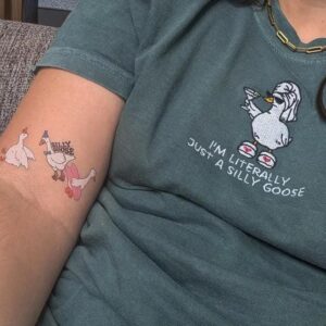 Person wearing a blue spruce Silly Goose Martini Embroidered T-Shirt