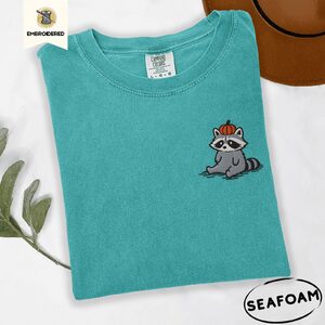Seafoam Sitting Raccoon With Pumpkin Hat Embroidered T-Shirt