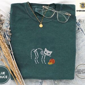 Blue Spruce Skeleton Cat and Pumpkins Embroidered T-Shirt