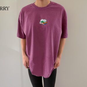 Person wearing a berry Sleeping Cat on Books Embroidered T-Shirt