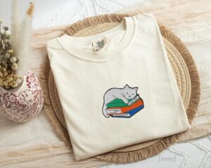 Ivory Sleeping Cat on Books Embroidered T-Shirt