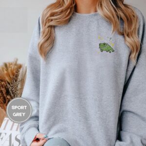 Person wearing a sport grey Space Frog and Satellite Embroidered Sweatshirt