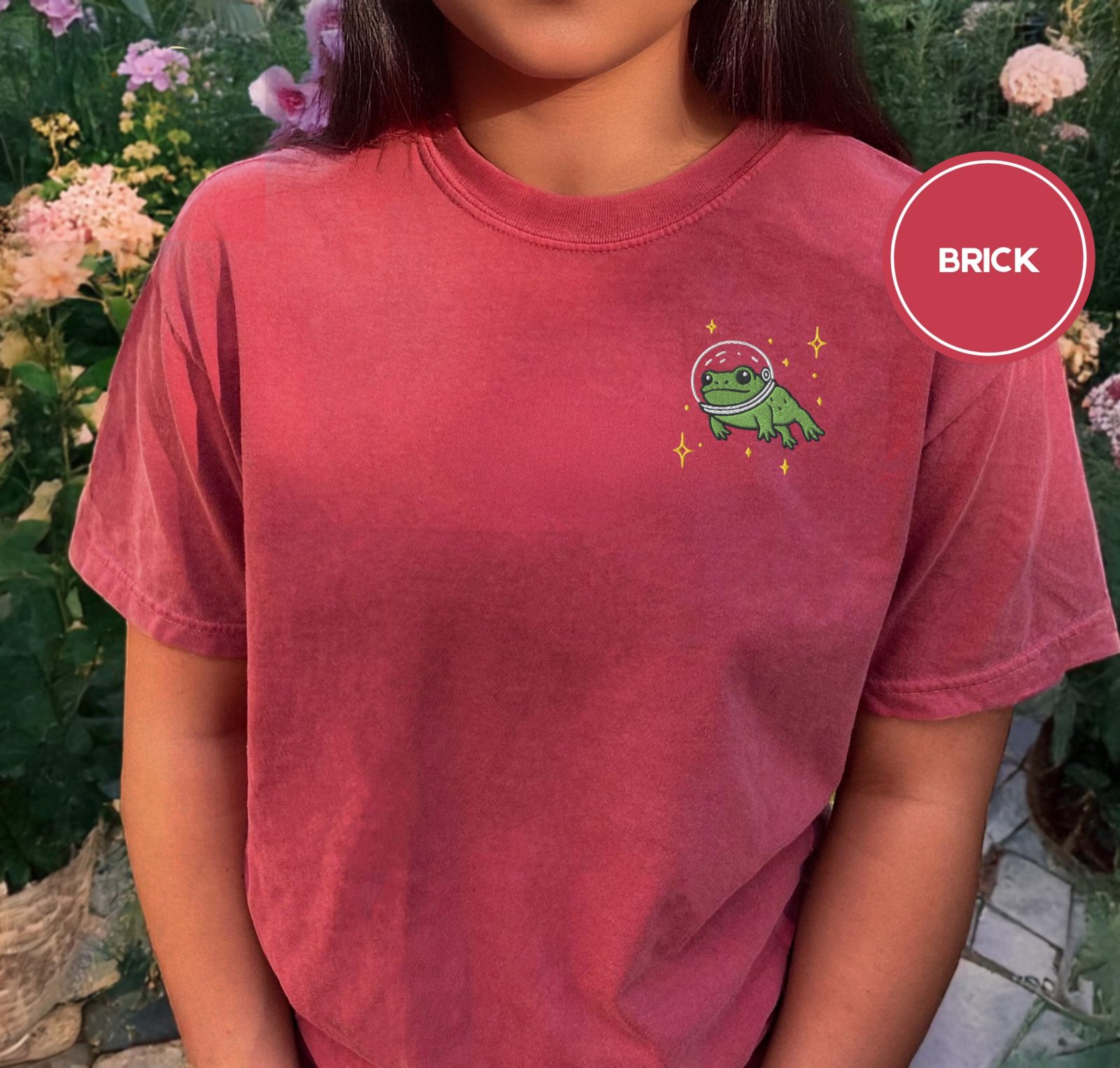Person wearing a brick Space Frog Embroidered T-Shirt