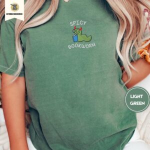 Person wearing a light green Spicy Bookworm Embroidered T-Shirt