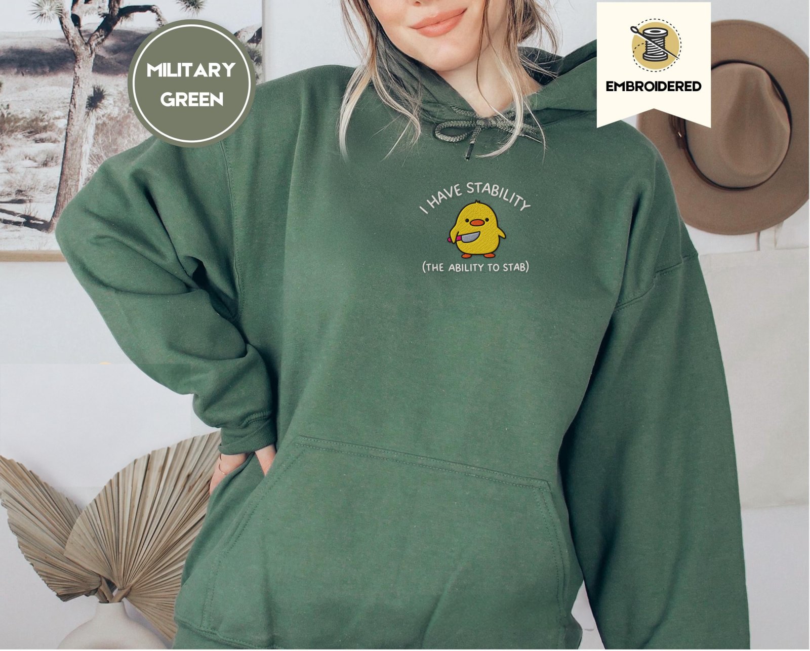 Person wearing a military green Stability Duck Embroidered Hoodie