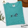 Seafoam Surfing Penguins Embroidered T-Shirt