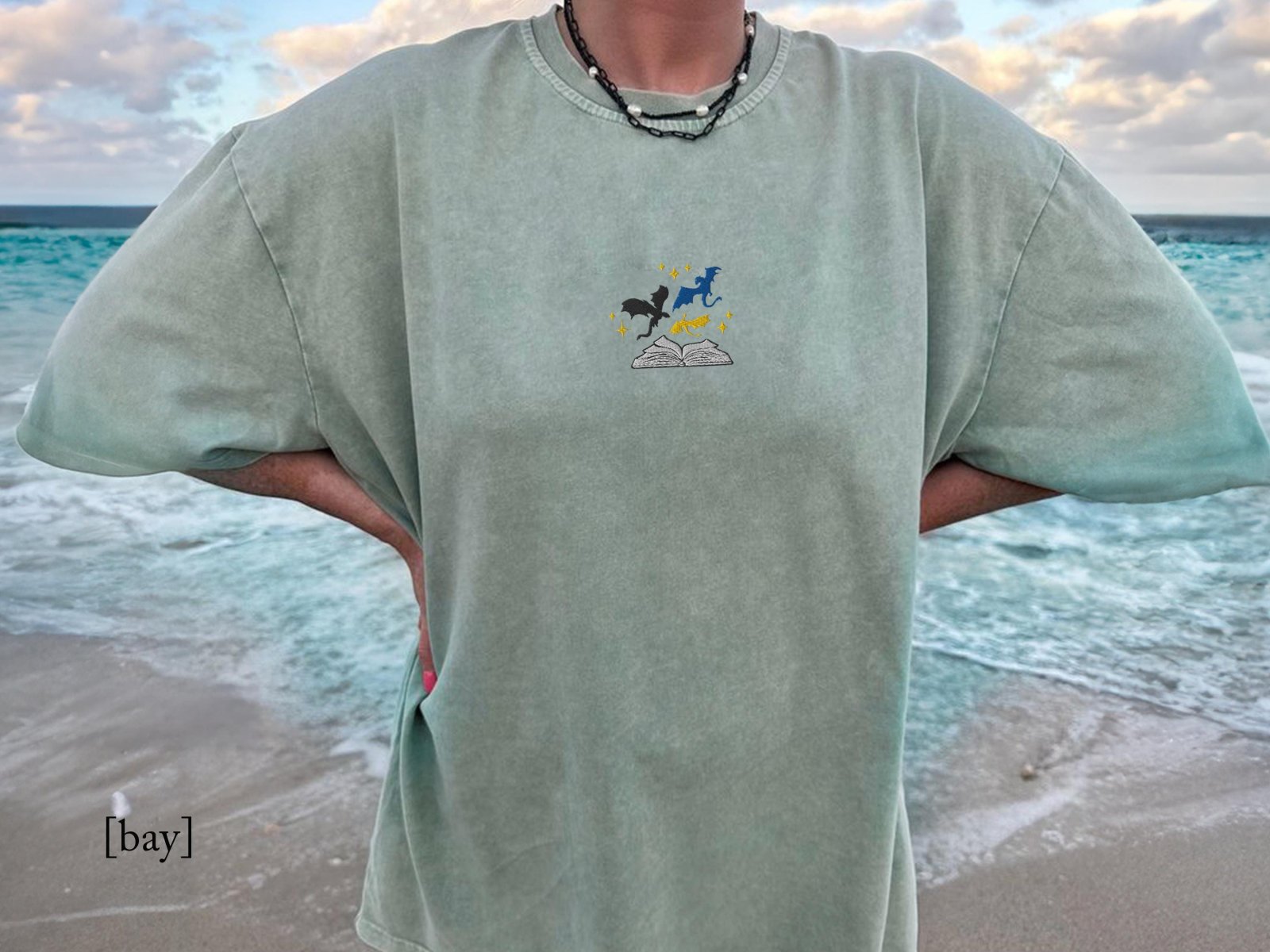 Person wearing a bay Three Dragons and Golden Stars Embroidered T-Shirt