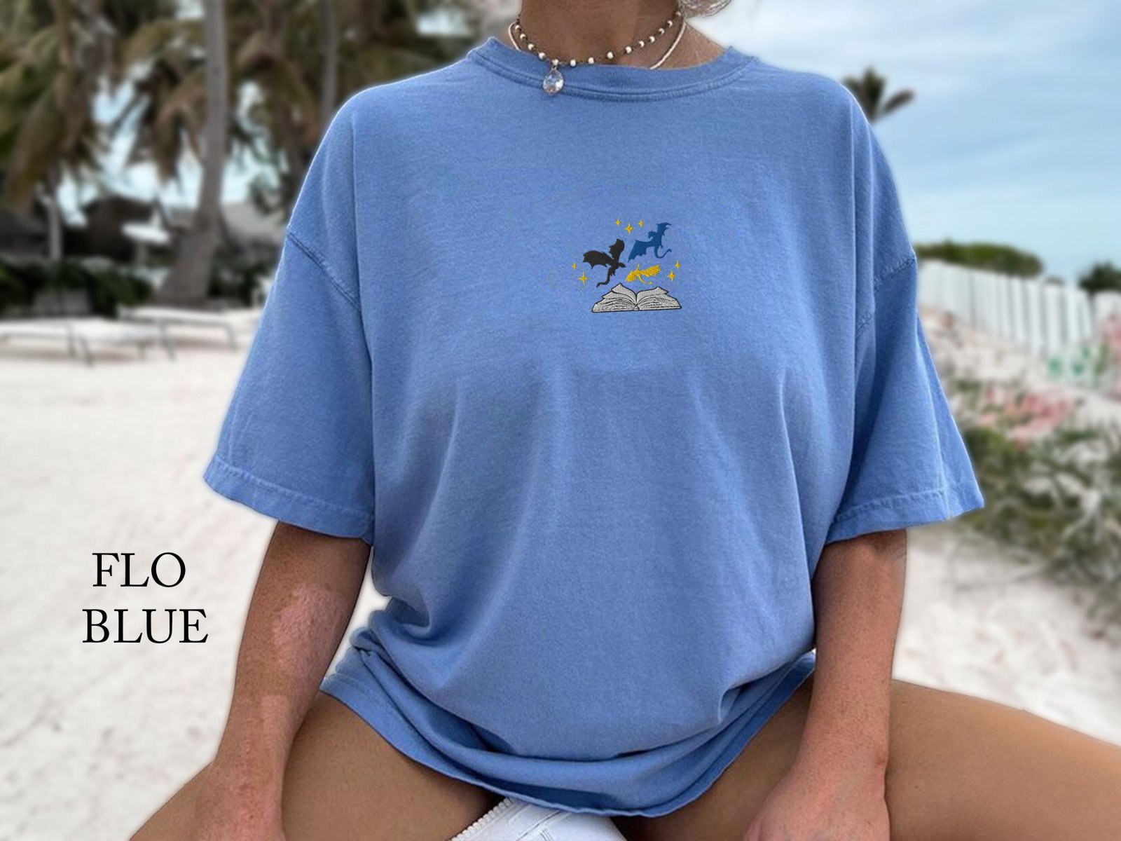 Person wearing a flo blue Three Dragons and Golden Stars Embroidered T-Shirt