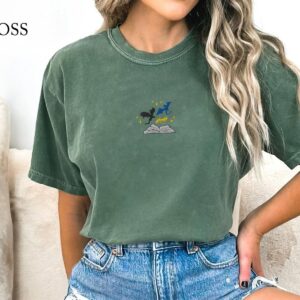 Person wearing a moss Three Dragons and Golden Stars Embroidered T-Shirt