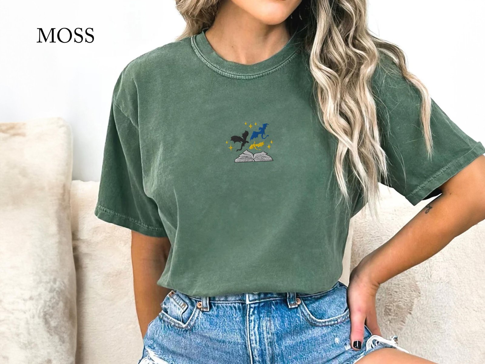 Person wearing a moss Three Dragons and Golden Stars Embroidered T-Shirt