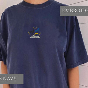 Person wearing a true navy Three Dragons and Golden Stars Embroidered T-Shirt