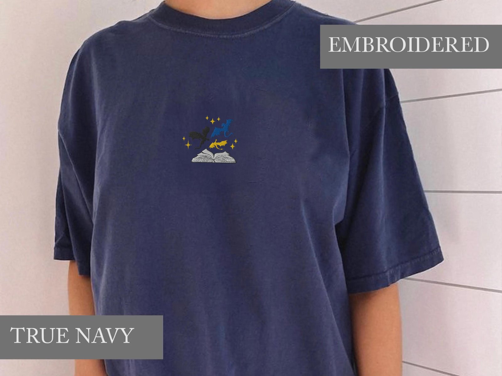 Person wearing a true navy Three Dragons and Golden Stars Embroidered T-Shirt