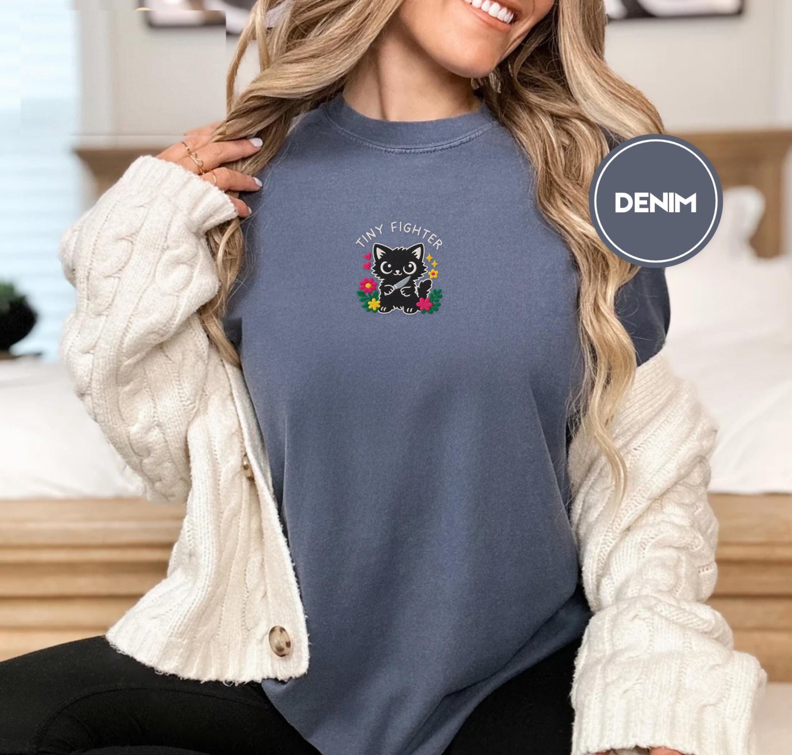 Person wearing a denim Tiny Fighter Cat Embroidered T-Shirt