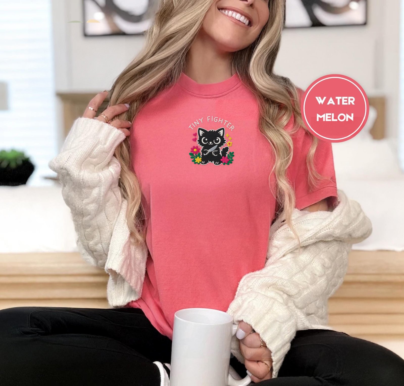 Person wearing a watermelon Tiny Fighter Cat Embroidered T-Shirt