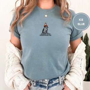 Person wearing an ice blue Traffic Cone Cat Embroidered T-Shirt