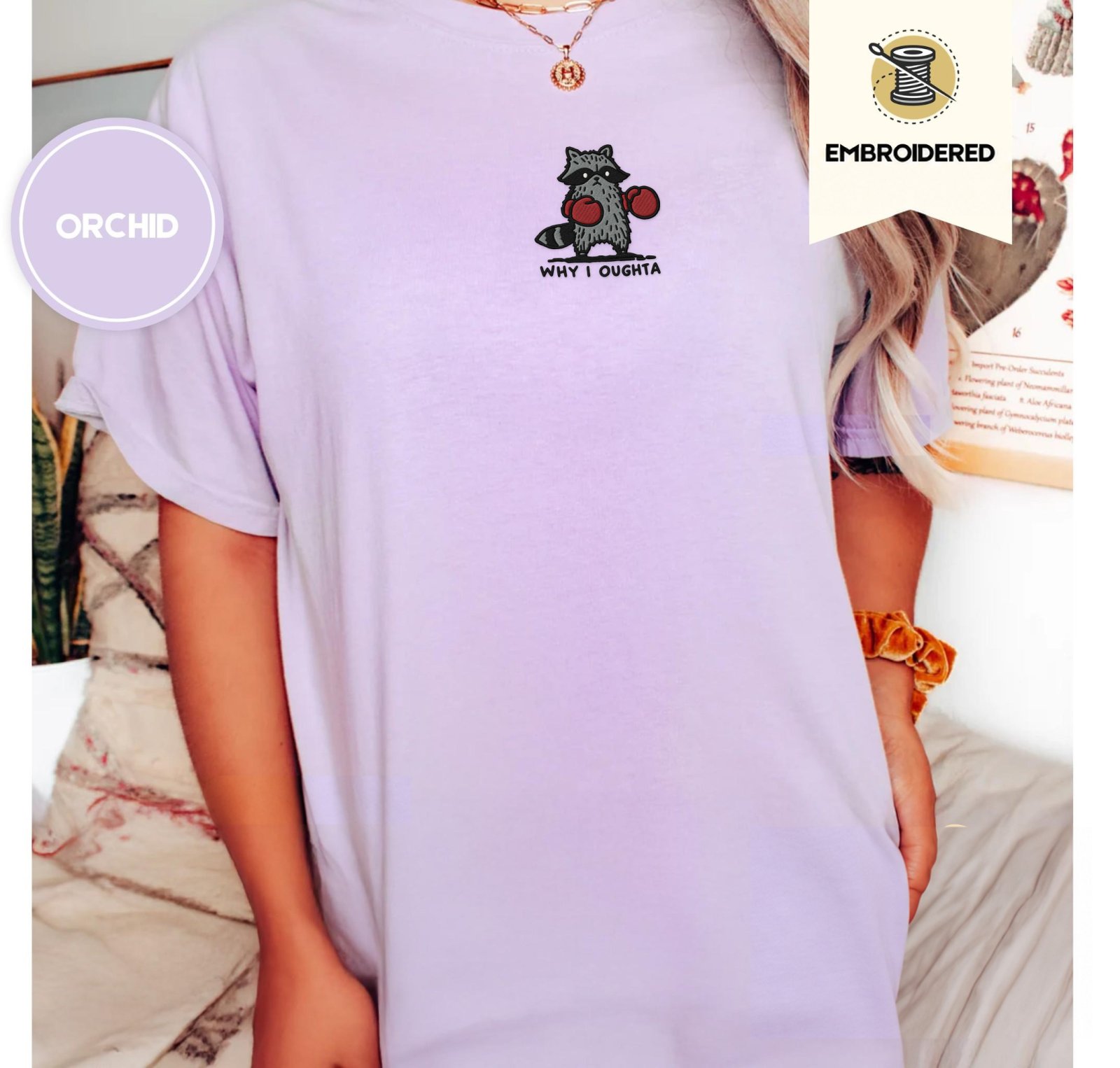 Person wearing an orchid Why I Oughta Boxing Raccoon Embroidered T-Shirt