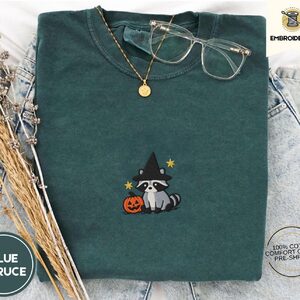 Blue Spruce Witch Raccoon and Pumpkin Embroidered T-Shirt