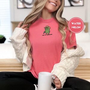 Person wearing a watermelon Wot in Tarnation Cowboy Frog Embroidered T-Shirt