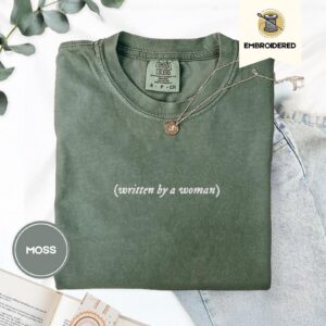 Flat lay of the Written By A Woman Embroidered T-Shirt